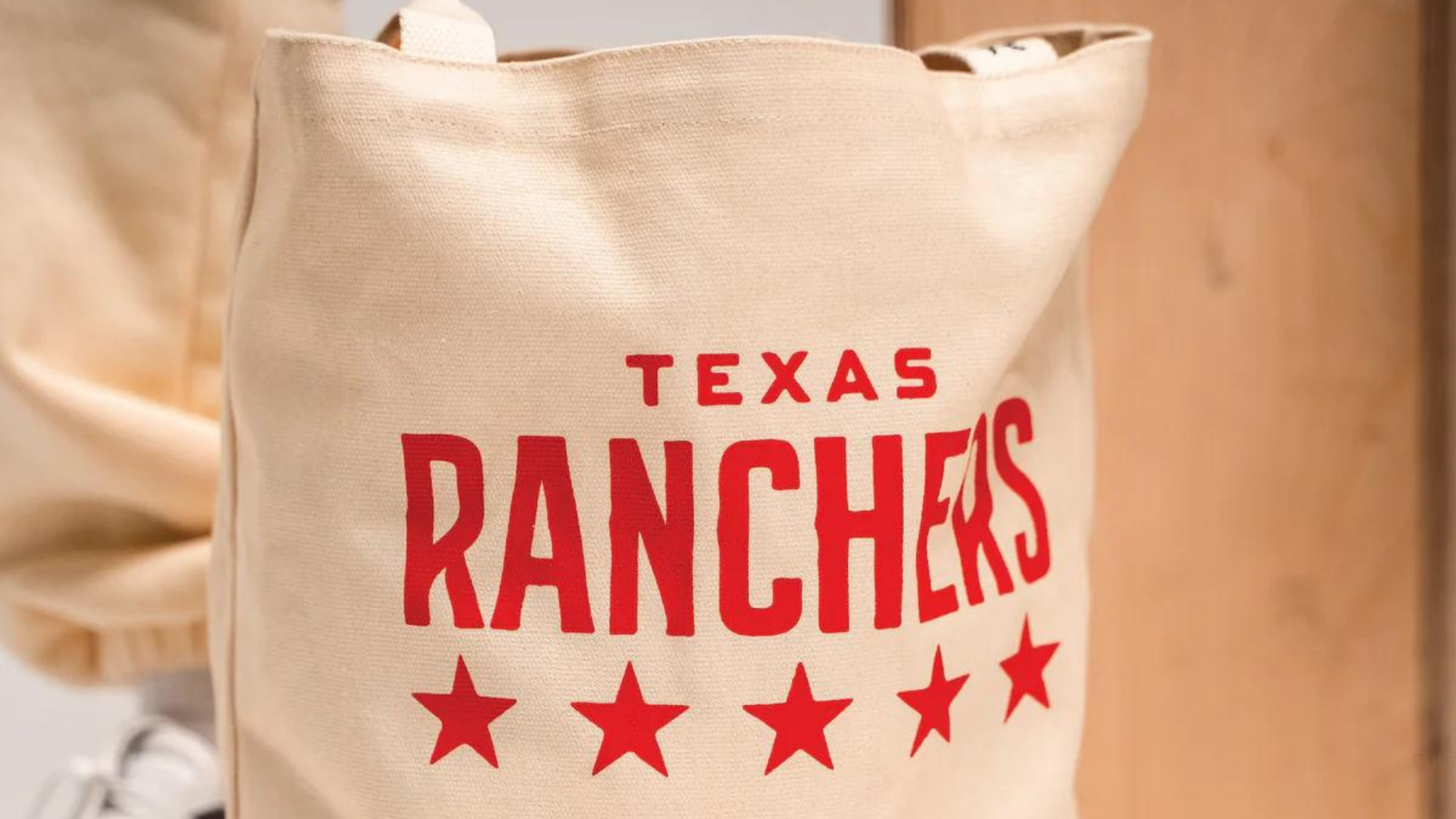 a stylish tote bag with a Texas Ranchers design