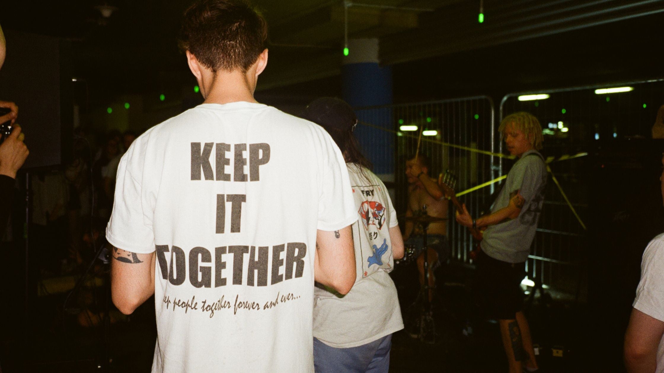 a man in a white t-shirt with the words "keep it together" printed on it