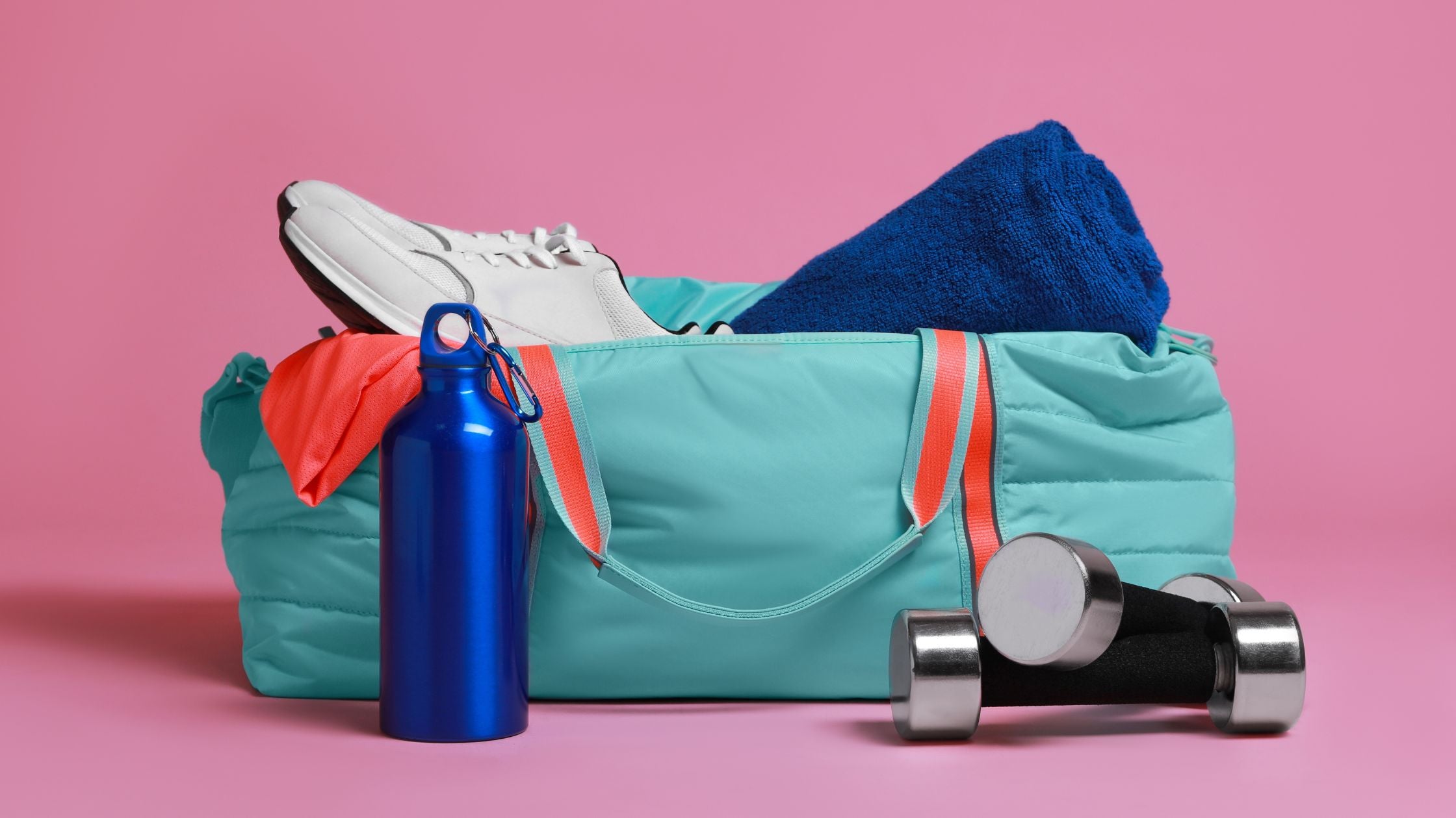 blue bag containing a towel, water bottle, sneakers, and a dumbbell
