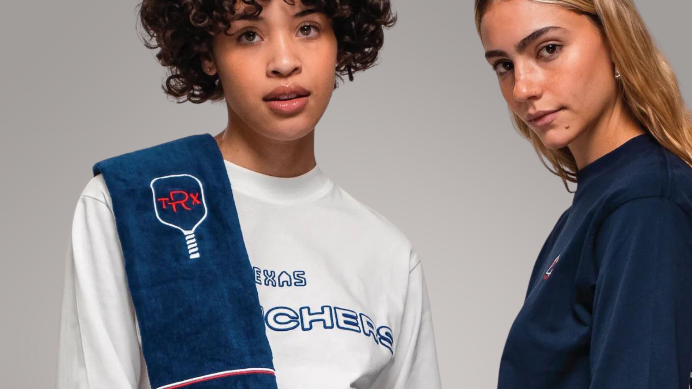 two young women in sportswear with towels