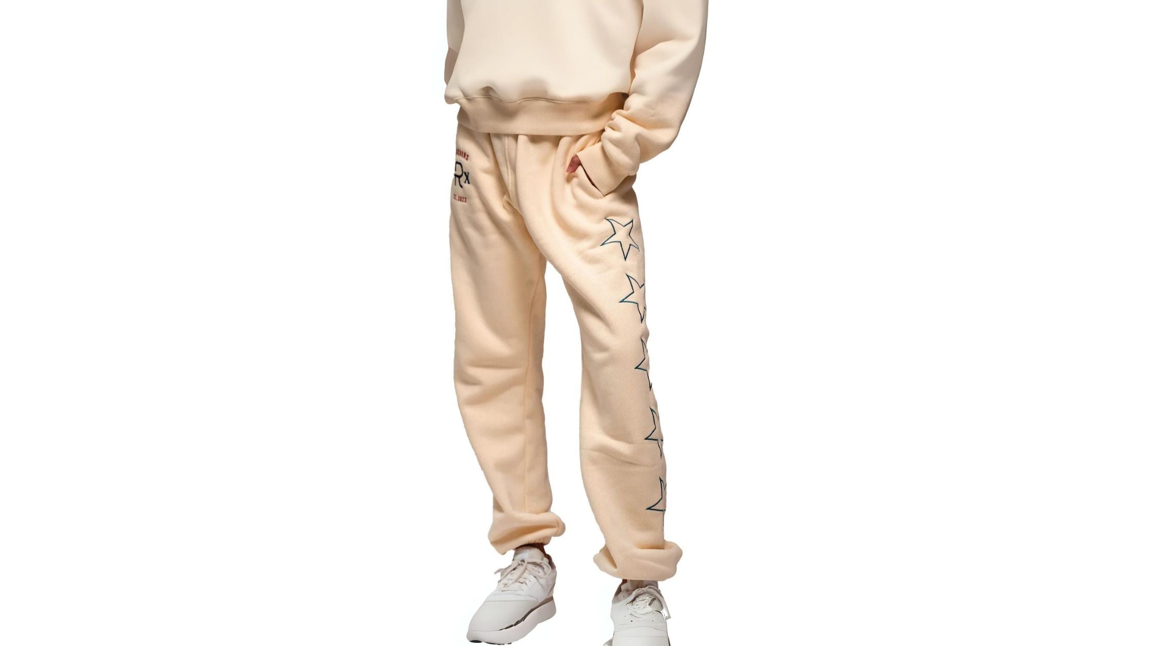 a model in cream sweatshirt and sweatpants by Ranchers, creating a cozy and stylish look