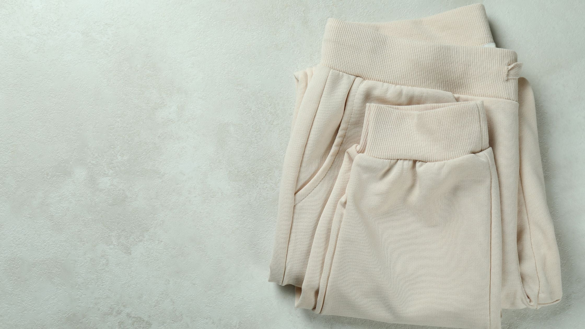 beige sweatpants on a plain background