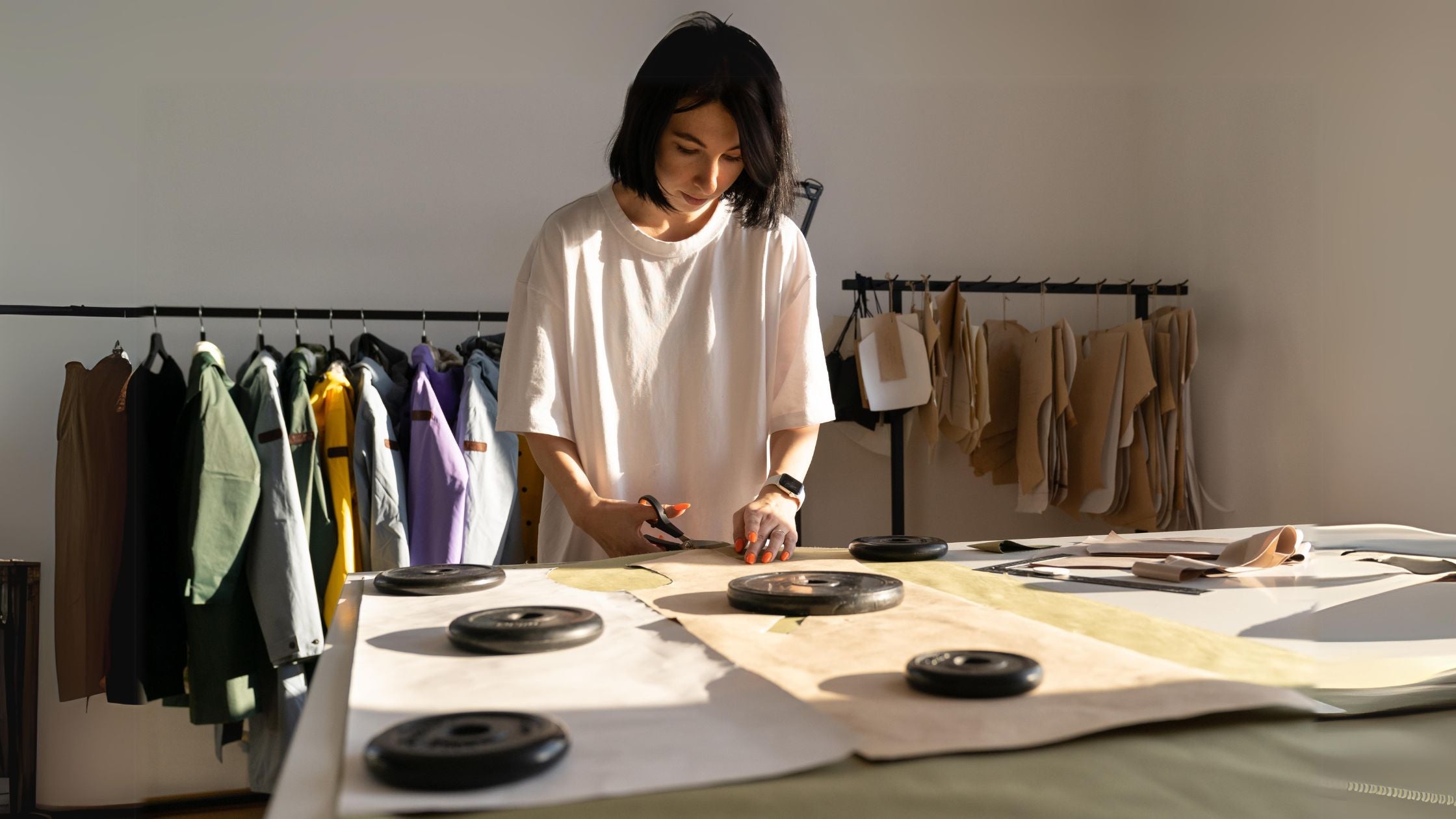 a woman cutting clothing sewing patterns with scissors