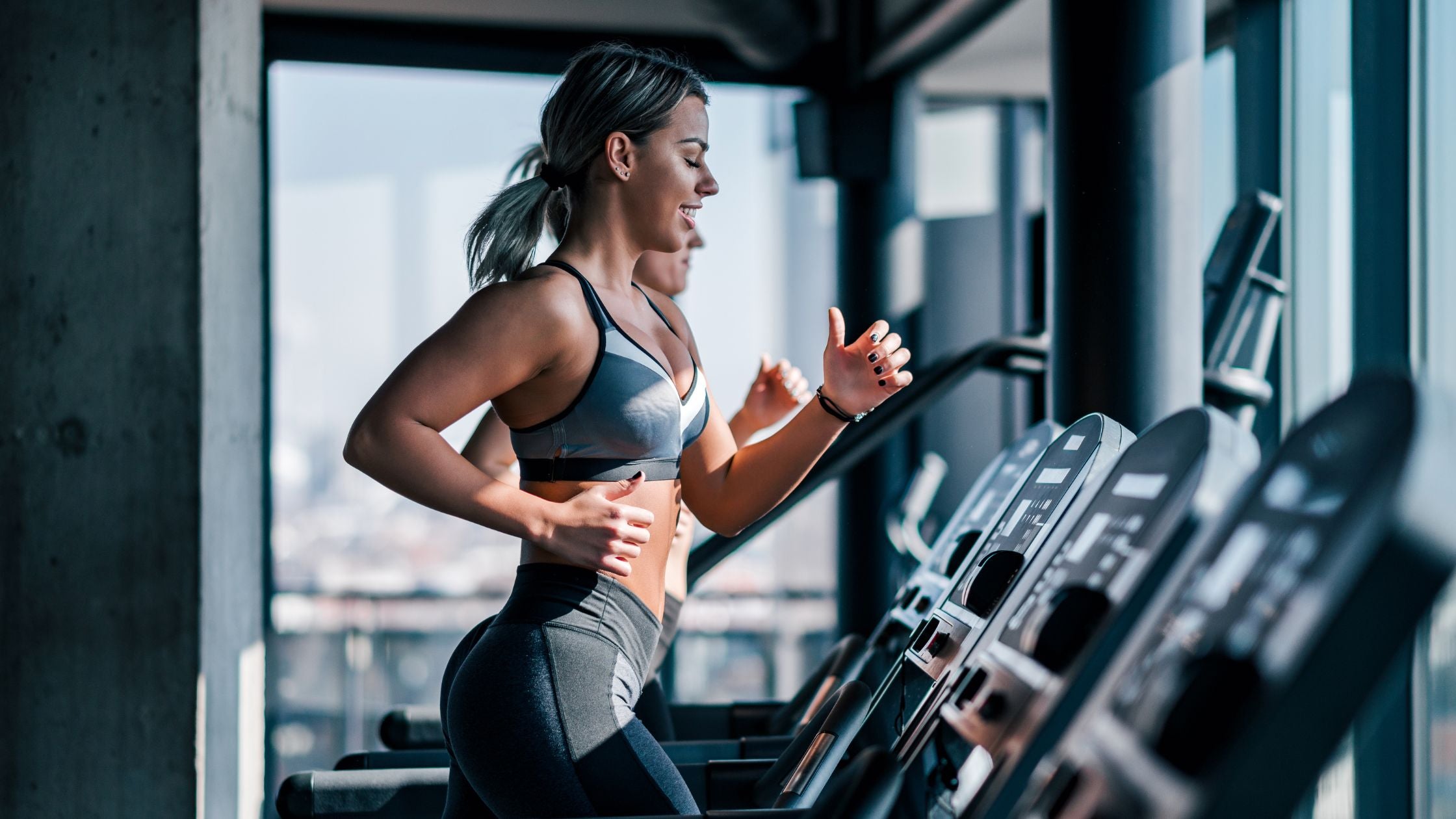 woman running on treadmill in gym