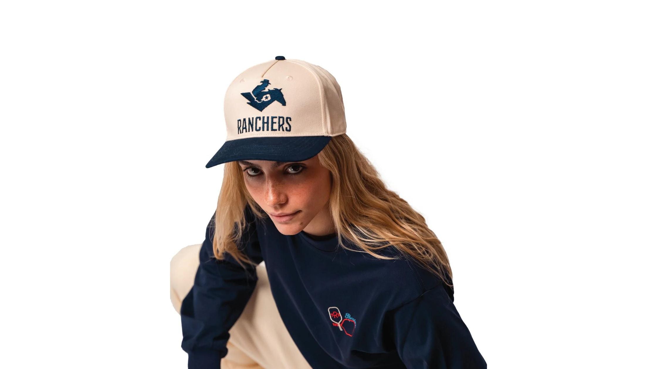 a woman wearing a hat and a navy long sleeve shirt by Ranchers