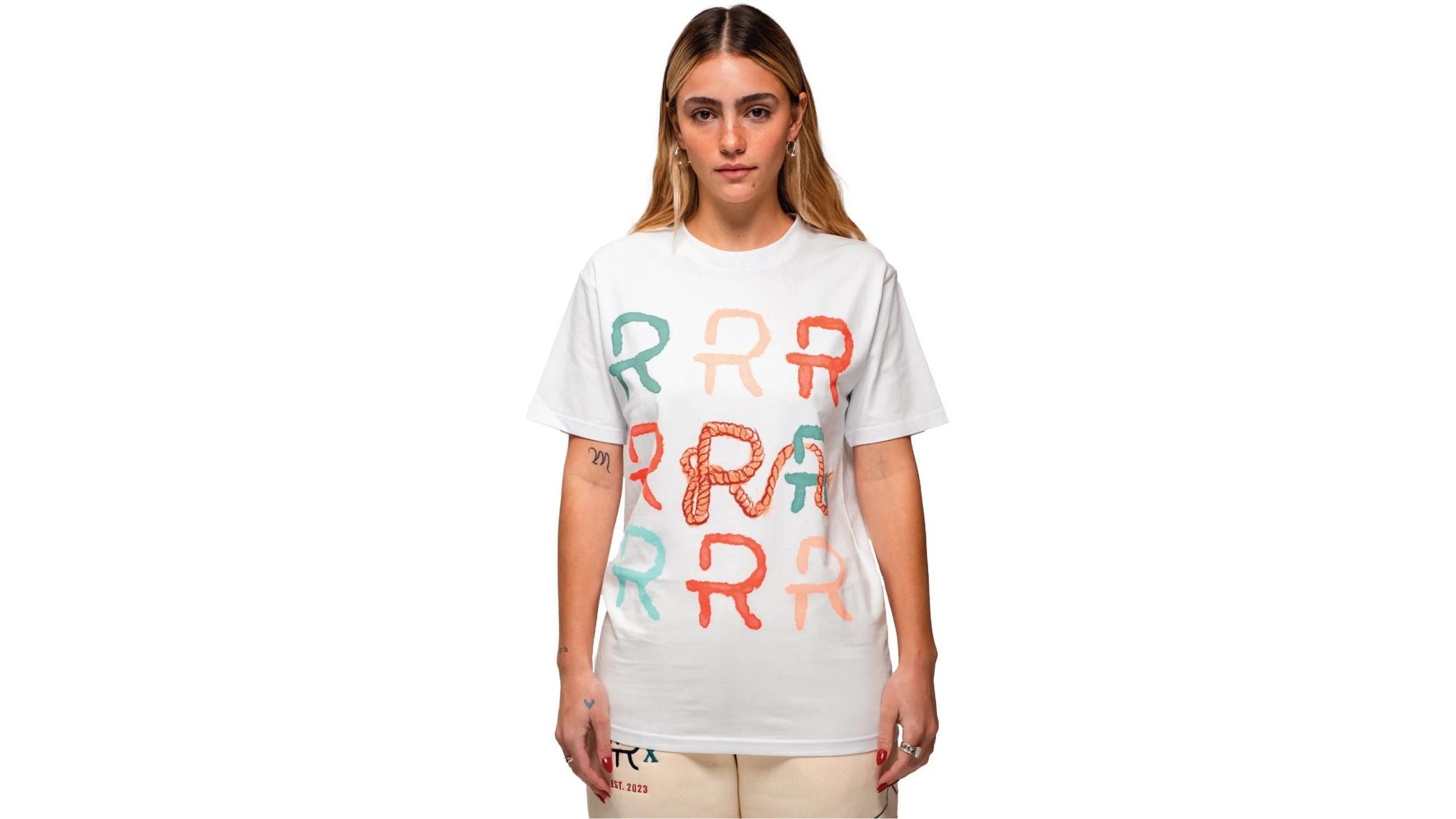 a woman in a white tee with a letter "R" and lasso design by Ranchers